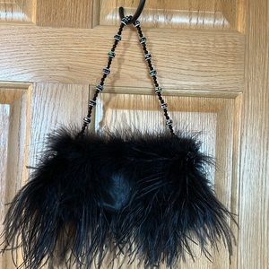 Black satin evening bag with Ostrich feather trim. Beaded handle.